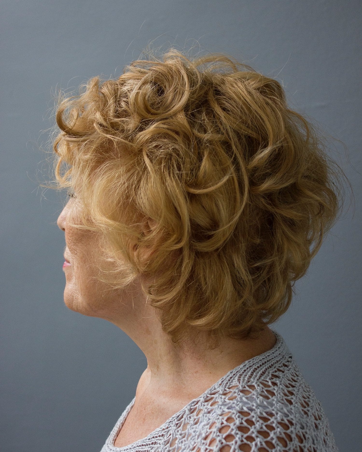Woman with wavy blonde hair wearing a hair topper in london